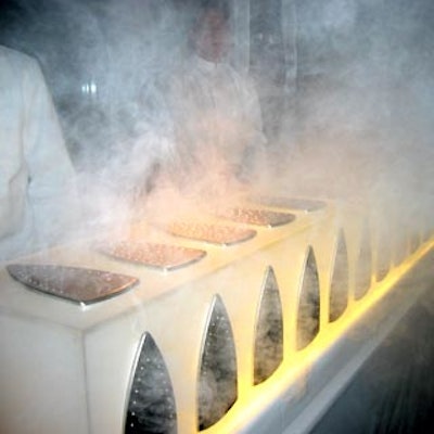 Franck Cursat of Olivier Cheng Catering & Events designed a Lucite bar decorated with Rowenta iron soleplates that emitted blasts of smoke to imitate steam.