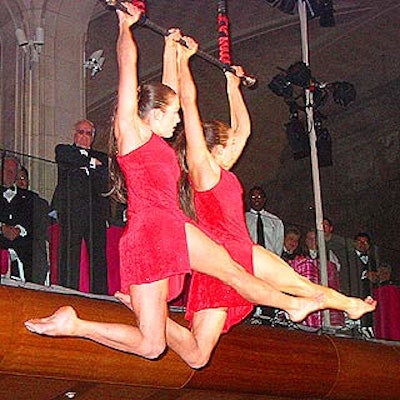 Twin acrobatic performers from Cirque du Soleil's O show swung above guests after the cocktail hour to call them upstairs to dinner and gaming.