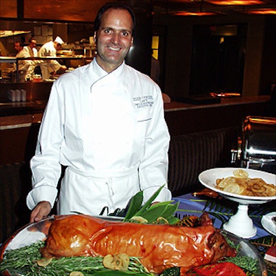Theo Schoenegger, executive chef of Rock Center Cafe at Rockefeller Center, with a roast suckling pig.