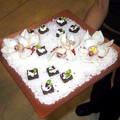 Chef & Company served hors d'oeuvres—including asparagus and goat cheese fondue—on trays decorated with fresh flowers.