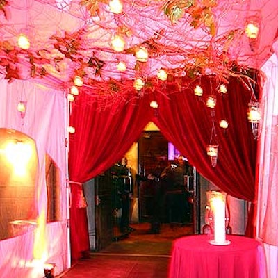 Mark Musters decorated the ceiling of a passageway with branches and candles suspended from wire and glass candleholders.