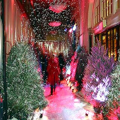 Next Level Floral Design spray-painted fresh Christmas trees pink and silver and scattered fake snow in the entryway to the event.