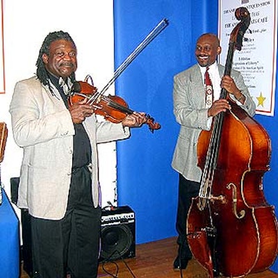 A bass and fiddle player from Performing in Public Spaces entertained guests with upbeat folk music.