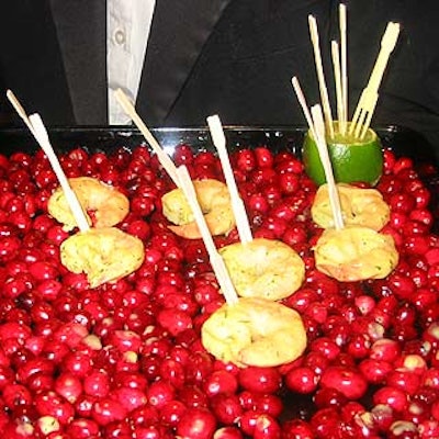 Taste served hors d'oeuvres like shrimp marinated with Dijon, shallots and fresh dill on wooden trays lined with bright red cranberries.