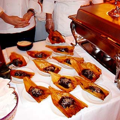 Zocalo restaurant served tamales with brown sauce served in corn husks.