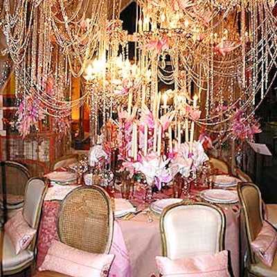 Romance played into ABC Carpet & Home's pretty-in-pink design, which had numerous chandeliers draped in silver beads and adorned with pink birds. A pink patchwork cloth covered the table and guests sat in mismatched chairs.