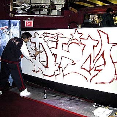 Graffiti artists tagged signs at Stuff magazine's 70's- and 80's- themed launch event for Fila's new clothing line at Show.