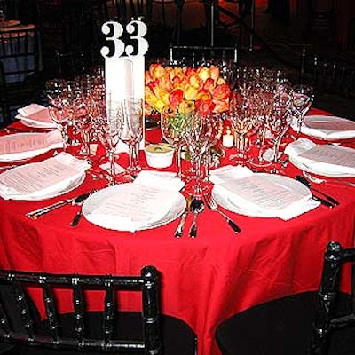 Tables were topped with extra large cutout table numbers to make it easy for guests to find their seats, and ZeZe Flowers arranged tulip bunches in complementary colors in clear vases.