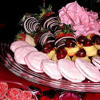 A silver dessert tray offered pink macaroons with raspberry filling, meringue hearts with raspberry mousse, chocolate-dipped strawberries and bite-sized cherry cheesecakes.