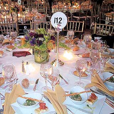 Dinner tables were decorated with flower arrangements by Distinctive Floral Designs.