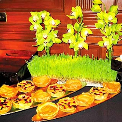 Dessert food stations offered fruit tarts and cookies surrounded by wheatgrass and flowers.