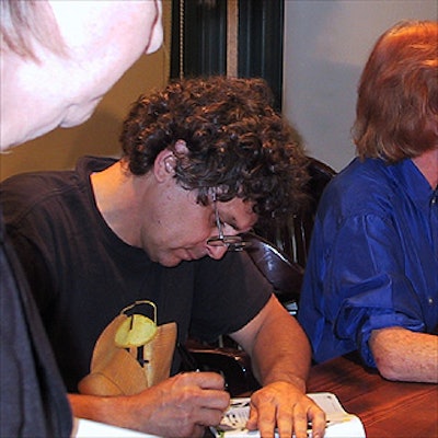 CowParade artists (left to right) Randy Gilman, Edwina Sandys and Martie Holmer autographed copies of CowParade New York.