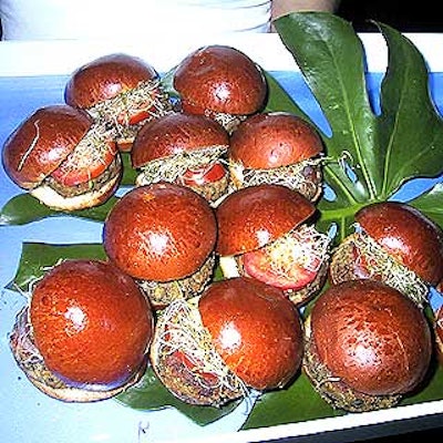 Match Catering and Eventstyles served mini veggie burgers with tomatoes and sprouts on trays lined in blue.