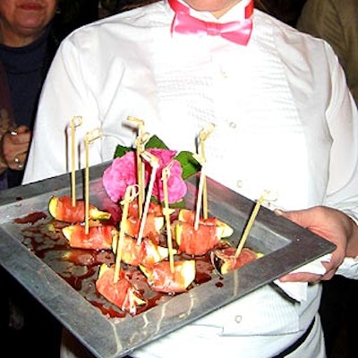 Sage Events served prosciutto-wrapped figs on a steel tray. Caterwaiter uniforms were accented with pink bow-ties.