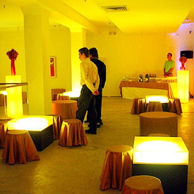Low, underlit cocktail tables paired with gold fabric-covered seats dotted the second floor mezzanine.