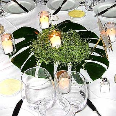 Event producer Mara Medoff used single Elephant Ear leaves and fresh grass set off by votives as centerpieces.