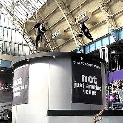 The giant Concept Centre booth drew attention with a variety of performers on top of its booth, including a pair of aerialists.