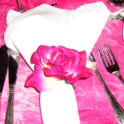 Individual silk roses from TriServe Party Rentals decorated the napkins.