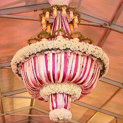 A 12- by 8-foot chandelier draped with white, purple, lavender and pink ribbons and accented with white hydrangea hung from the ceiling of the tent at Lincoln Center of the Performing Arts' 'Thank You, Beverly' spring benefit gala.