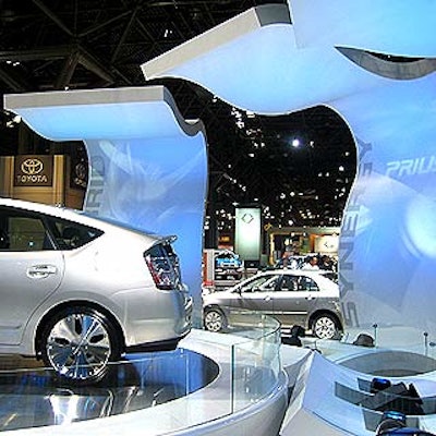 Shiny white undulating panels surrounded the Toyota Prius display at the New York International Auto Show at the Javits Center.