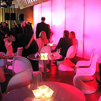 A lounge-inspired seating area was created for the awards ceremony with mod white and black furniture from Props for Today and a wall backlit with changing colors.