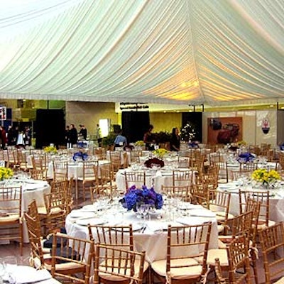 In the north end of the space, a tent created by suspended white fabric created a spare, pretty dining room accented with red, blue and yellow floral centerpieces by Bill Tansey.
