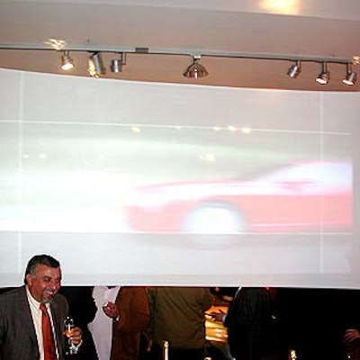 Lighting designer Arthur Weinstein stretched sheer white fabric across support beams in the Heller Gallery and showed video images of Bentley race cars on the makeshift movie screen.