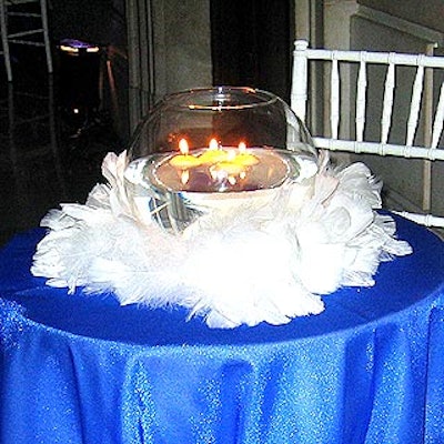 In heaven, Musters & Company's centerpieces had floating candles in large globes surrounded by white feathers.
