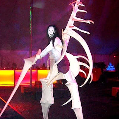 A stiltwalker from Hollywood Pop Gallery in a costume inspired by a seashell from Aruba stalked around the party.