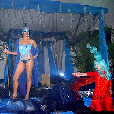 An actress dressed as the queen of the sea posed on the blue grotto decor set.