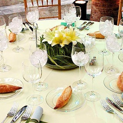 The focal point of each table was a low, lush centerpiece made from a bed of grass encircled by palm fronds and topped with three pale, lemon-colored lilies.