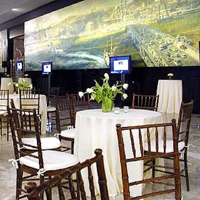 Tables in the cocktail area were draped with simple, crisp linens and topped with centerpieces of clear, cylindrical vases brimming with white tulips.