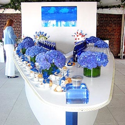 A white, boat-shaped counter decorated with blue hydrangea, blue bottles of water and blue drinking glasses was the decorative centerpiece at the Ralph Lauren Blue fragrance launch at the penthouse at the Hudson Hotel.