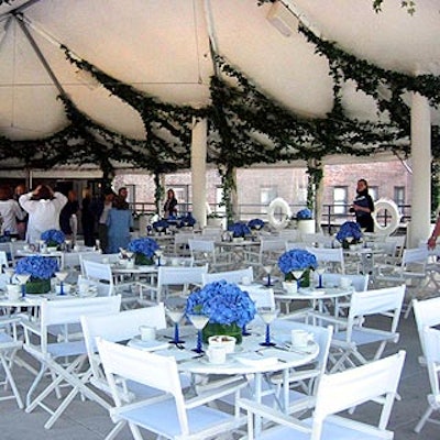 The tented patio was filled with white folding chairs and tables topped with more hydrangea. Caterwaiters were dressed in white pants and white Polo shirts.