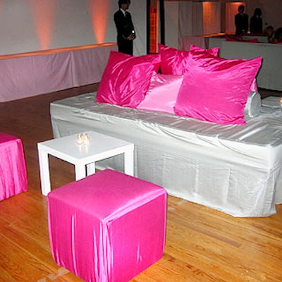 In the Altman Building, a chic silver and hot pink lounge was created for the cocktail hour with silver couches, pink pillows and paired with hot pink cube-shaped stools.