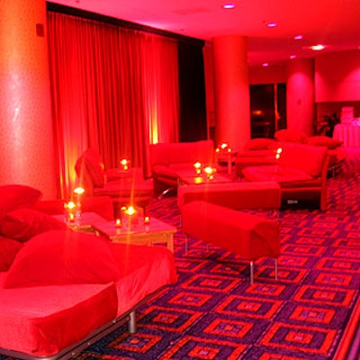 A lounge filled with red bed seats, benches and couches gave guests mingling room outside the Broadway Ballroom.
