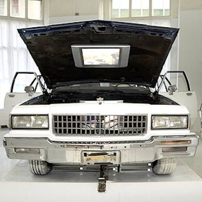 Two more TVs were installed under the hood of a white car.