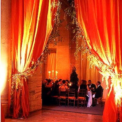 Robert Isabell designed grand-looking persimmon-colored silk curtains trimmed with thousands of individual Swarovski crystals for the archways in Astor Hall.