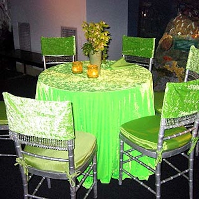 Field covered tables with lime green fabric and matching chair covers lined with crystal beads, while centerpieces varied from table to table.