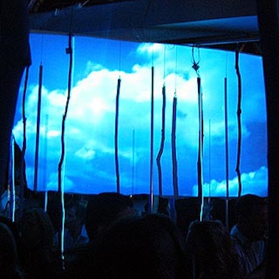 Musters' decor included projection screens showing blue sky and water imagery and large mobiles with small mirror balls, long pieces of Lucite and branches in different areas.