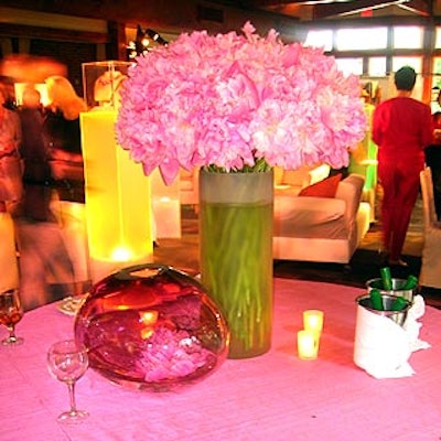 Vases and custom-blown glass orbs filled with flowers decorated the raw-silk tablecloth covered tables.