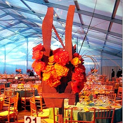 Musters & Company created tall, unusual centerpieces that mixed flowers with pieces of wood for an arty look.