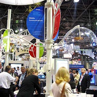 Siemens' booth had white tressing, colorful signage and transparent half-bubble caps suspended over each computer station.
