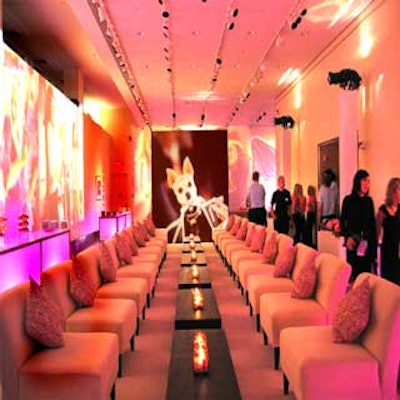 Two rows of lounge furniture faced each other in another room, and stills from the film were projected on the walls. White bars with pink lights inside lined the walls.