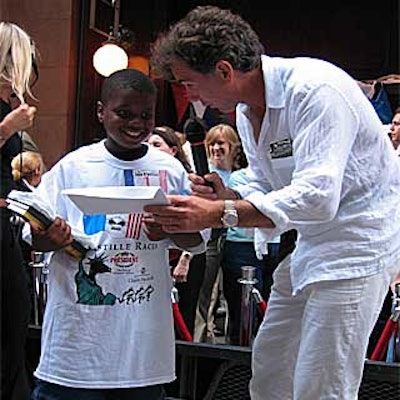 Ray Raymond, winner of the children's race, was congratulated by Philippe Lajaunie, co-owner of Les Halles and Les Halles Downtown.