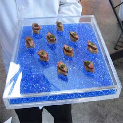Olivier Cheng Catering and Events incorporated blue crystals into the Lucite serving trays.