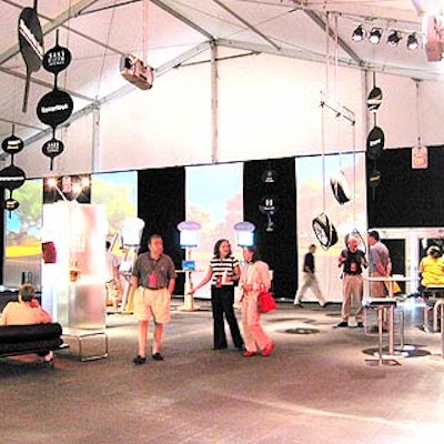 A sponsorship area with white wall panels illuminated with animated video projections featured displays by Saks Fifth Avenue, Continental tires and Bliss spa.