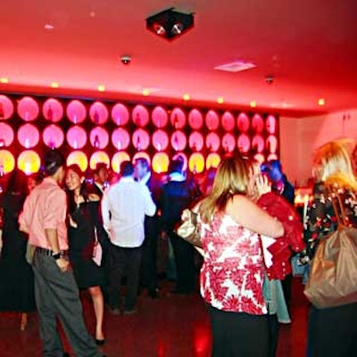 At French Connection UK's fragrance launch, bottles of the fragrance were displayed in LQ's circular cutout wall backlit with red lights.