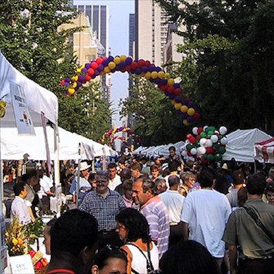 Crowds passed through balloon arches from Balloon Bouquets of New York to sample food from Times Square area restaurants under tents from Cabaret Tent Rental & Party Supplies.