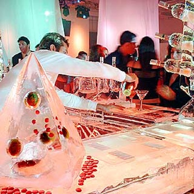 Small, pyramid-shaped ice sculptures with cranberries and limes suspended inside topped the large ice bar.
